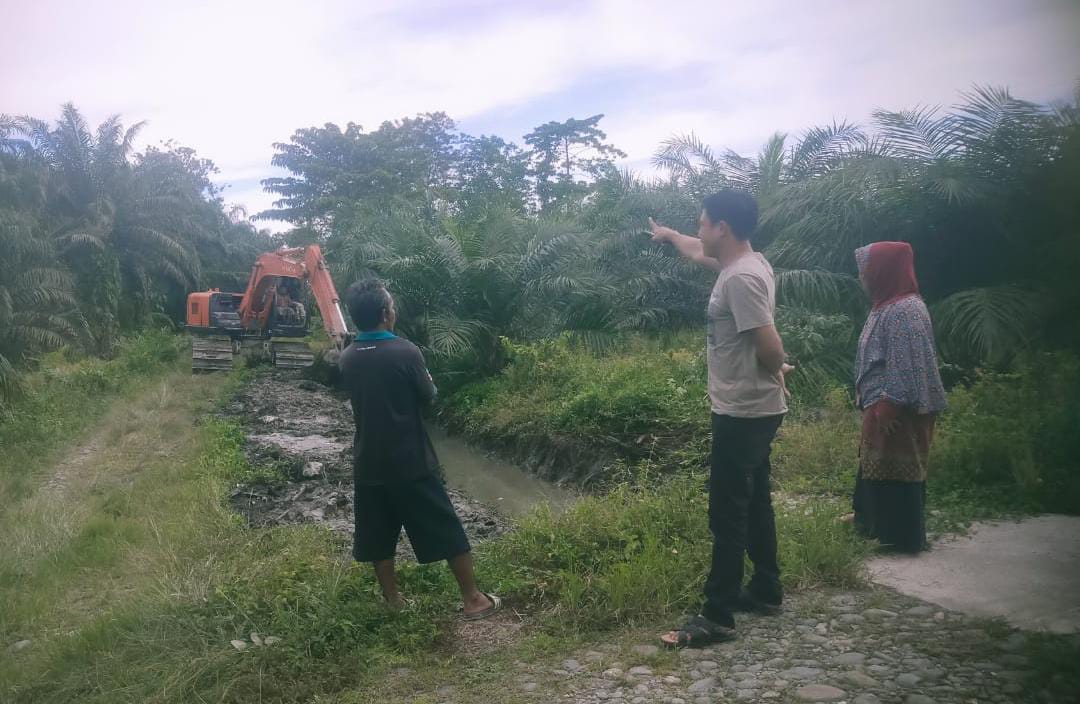 Anggota DPRD Luwu Utara Heriansyah Efendi (Baju Coklat) Saat Meninjau Pengerukan Saluran Irigasi di Desa Karondang