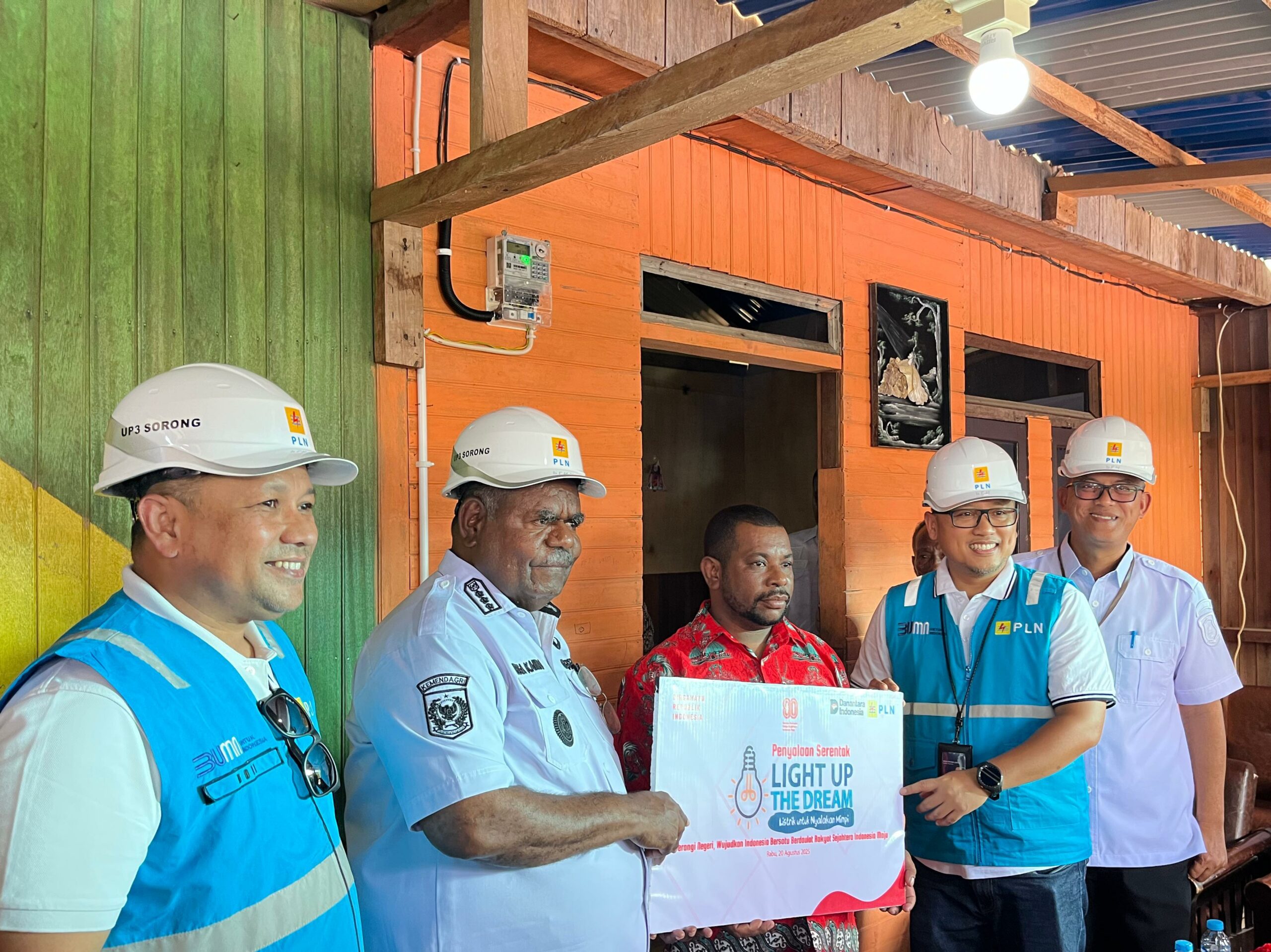 Gubernur Papua Barat Daya, Elisa Kambu (kedua dari kiri) Berfoto Bersama Salah Satu Penerima Manfaat Program Light Up The Dream (LUTD), Simon Sineri (tengah), Kepala Dinas ESDM Provinsi Papua Barat Daya, Suroso (kanan), General Manager PLN UIW Papua dan Papua Barat, Diksi Erfani Umar (Kedua dari Kanan), dan Manager PLN UP3 Sorong, Doni Hernandi (Kiri) Pascapenyalaan Simbolis Listrik Program LUTD di Sorong, Papua Barat Daya Pada Rabu (20/8). PLN Memberikan Kado Spesial Bagi Masyarakat di Hari Ulang Tahun (HUT) ke-80 Republik Indonesia Dengan Menyalurkan Bantuan Sambungan Listrik Gratis Serentak di 38 Provinsi Kepada 2.821 Keluarga Prasejahtera Melalui Program LUTD